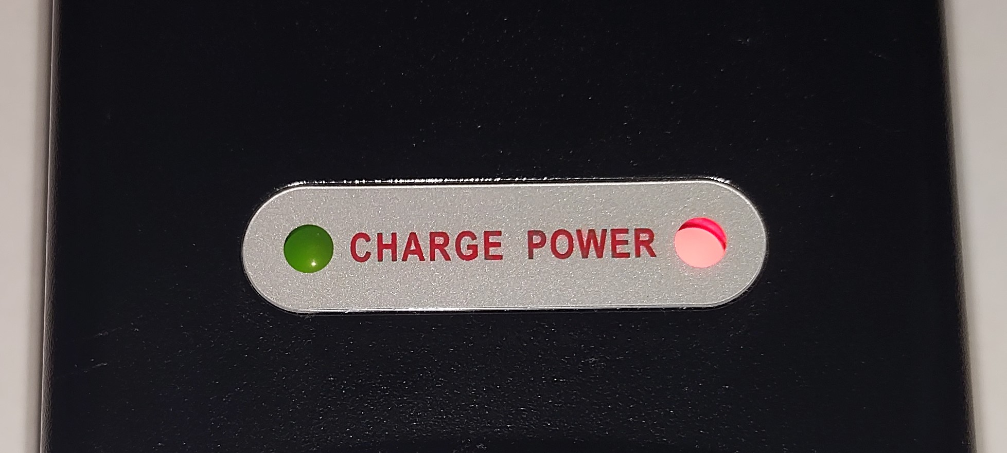 Rad charger with two indicator lights, one light is red and the other light has turned green